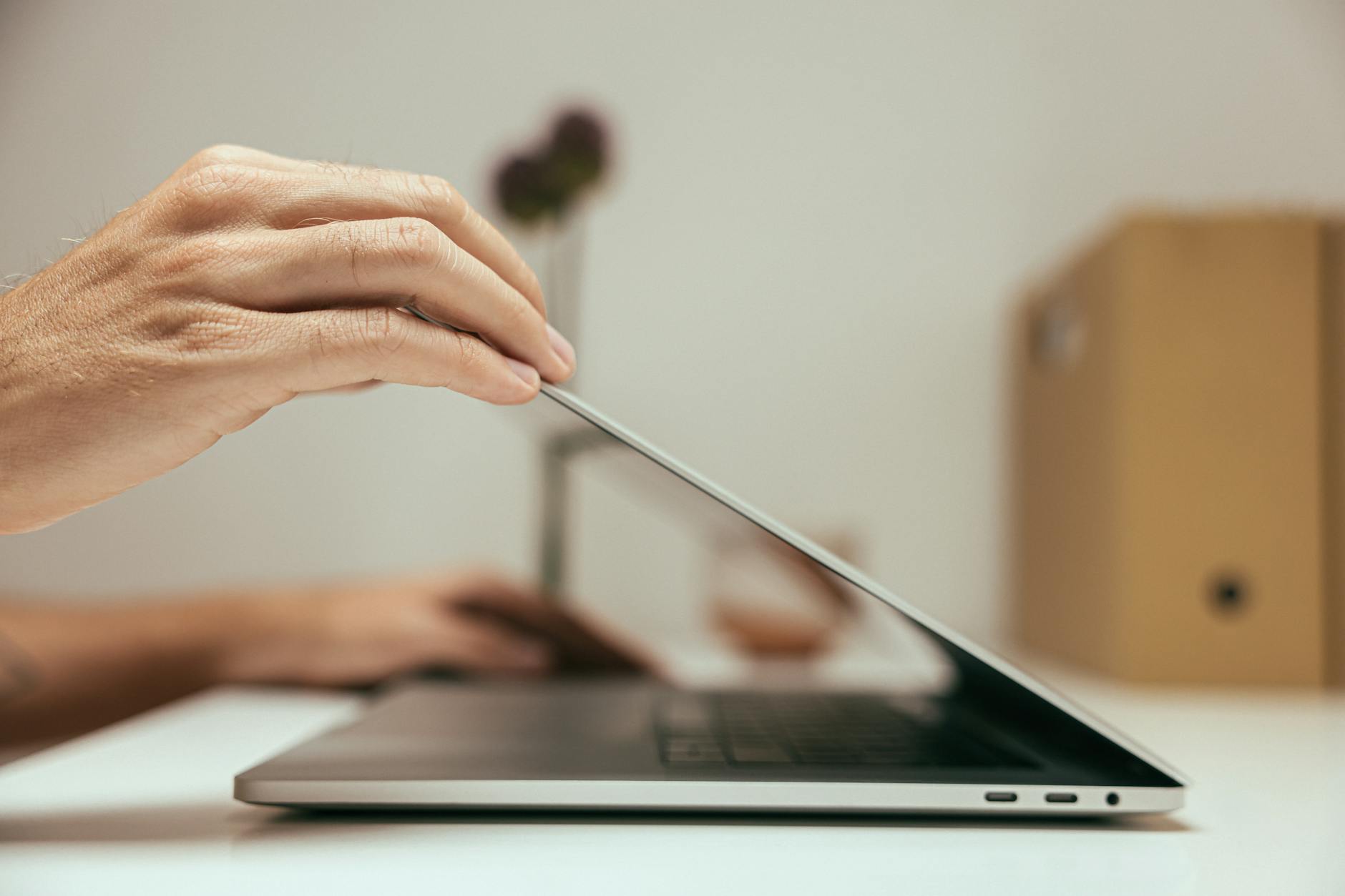 person opening a laptop